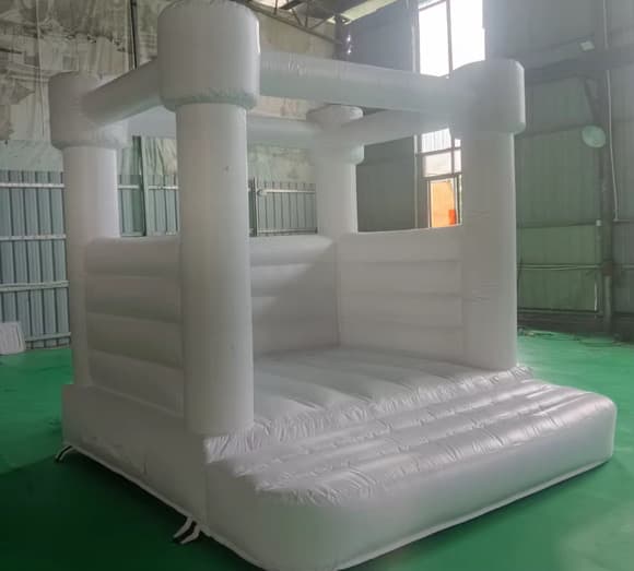 All-white inflatable bounce house, seen from the side
